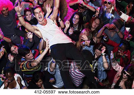 Man crowd surfing at music festival View Large Photo Image Stock Photo - Man crowd surfing at music festival. Fotosearch
