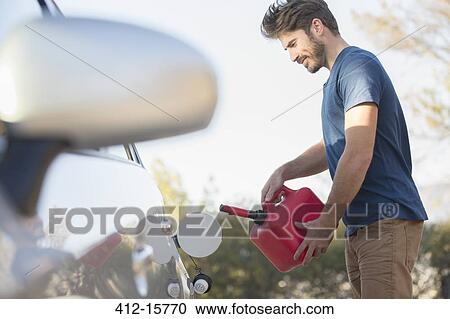 Man filling gas tank at roadside View Large Photo Image Stock Image - Man filling gas tank at roadside. Fotosearch