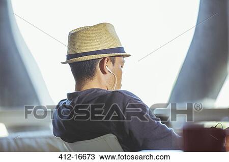 Man in fedora wearing headphones View Large Photo Image Stock Image - Man in fedora wearing headphones. Fotosearch