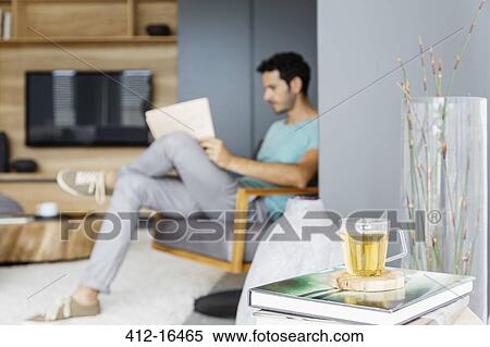 Man reading newspaper in living room View Large Photo Image Stock Photography - Man reading newspaper in living room. Fotosearch