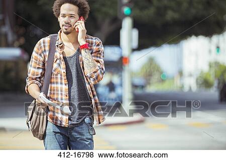 Man talking on cell phone in urban crosswalk View Large Photo Image Stock Photo - Man talking on cell phone in urban crosswalk. Fotosearch