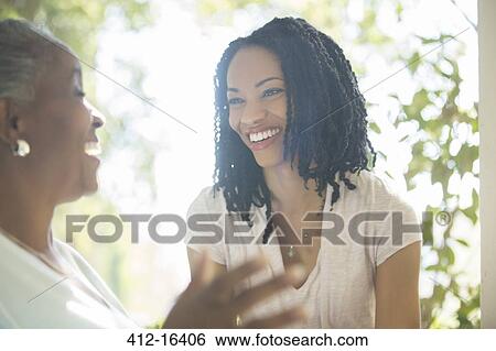 Mother and daughter laughing outdoors View Large Photo Image Stock Photograph - Mother and daughter laughing outdoors. Fotosearch