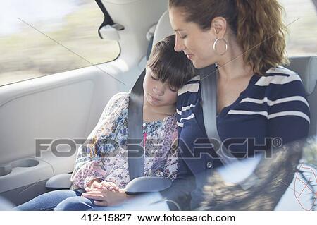 Mother and daughter sleeping in back seat of car View Large Photo Image Stock Photo - Mother and daughter sleeping in back seat of car. Fotosearch