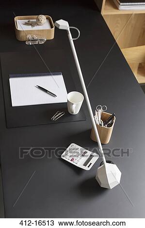 Objects and modern lamp on home office desk View Large Photo Image Stock Image - Objects and modern lamp on home office desk. Fotosearch