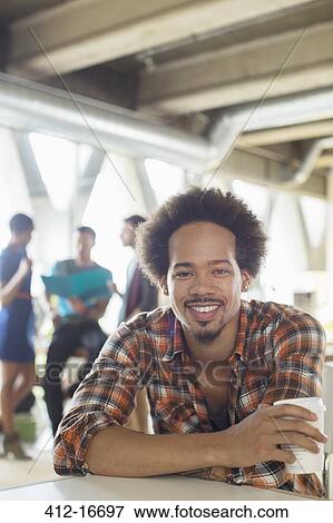 Stock Photo - Portrait of casual businessman drinking coffee. Fotosearch