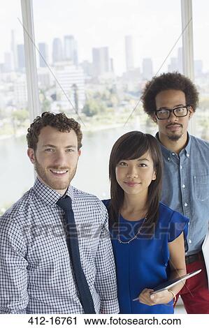 Portrait of confident business people at window overlooking city View Large Photo Image Stock Image - Portrait of confident business people at window overlooking city. Fotosearch