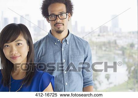 Portrait of confident business people at window View Large Photo Image Stock Photography - Portrait of confident business people at window. Fotosearch