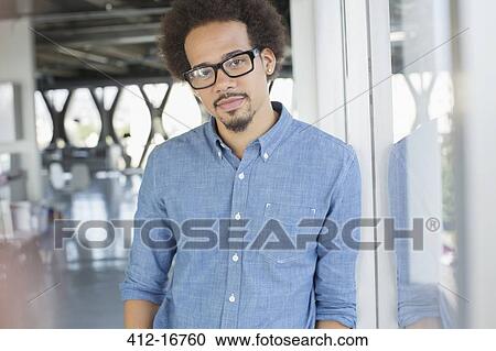 Portrait of confident businessman wearing eyeglasses View Large Photo Image Stock Image - Portrait of confident businessman wearing eyeglasses. Fotosearch
