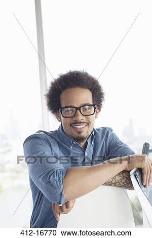 Stock Image - Portrait of confident casual businessman wearing eyeglasses. Fotosearch