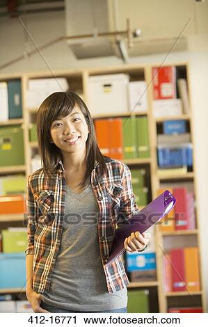 Stock Image - Portrait of confident casual businesswoman in office. Fotosearch