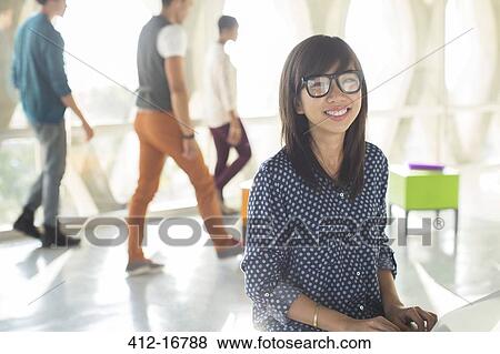 Portrait of confident casual businesswoman in sunny office View Large Photo Image Stock Photo - Portrait of confident casual businesswoman in sunny office. Fotosearch