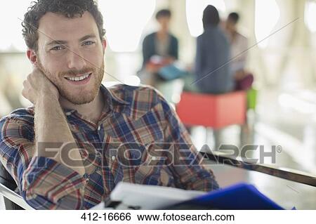 Portrait of confident casual businessman with paperwork View Large Photo Image Stock Photograph - Portrait of confident casual businessman with paperwork. Fotosearch