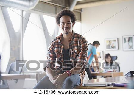 Stock Photograph - Portrait of confident casual businessman in office. Fotosearch