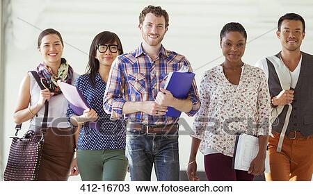 Stock Image - Portrait of confident creative business people walking in office corridor. Fotosearch