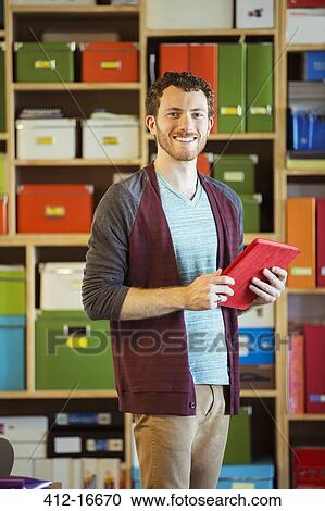 Portrait of confident creative businessman holding digital tablet View Large Photo Image Stock Image - Portrait of confident creative businessman holding digital tablet. Fotosearch