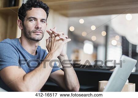 Portrait of confident man at laptop View Large Photo Image Stock Photo - Portrait of confident man at laptop. Fotosearch