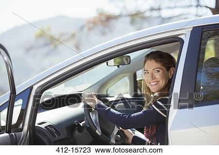 Portrait of confident woman inside car View Large Photo Image Stock Image - Portrait of confident woman inside car. Fotosearch