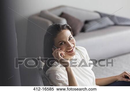 Stock Photography - Portrait of confident woman talking on cell phone. Fotosearch