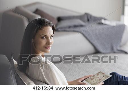 Portrait of confident woman using digital tablet in bedroom View Large Photo Image Picture - Portrait of confident woman using digital tablet in bedroom. Fotosearch