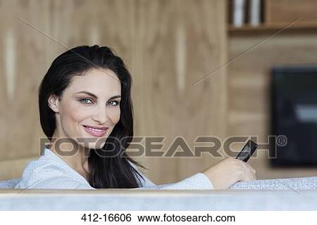 Portrait of confident woman using digital tablet on sofa View Large Photo Image Stock Photograph - Portrait of confident woman using digital tablet on sofa. Fotosearch