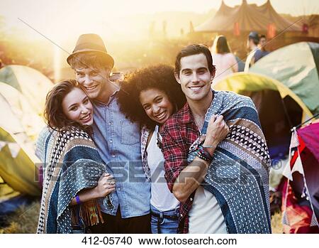 Portrait of couples wrapped in a blanket outside tents at music festival View Large Photo Image Stock Image - Portrait of couples wrapped in a blanket outside tents at music festival. Fotosearch