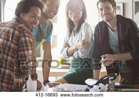 Portrait of creative business people in meeting at desk View Large Photo Image Stock Image - Portrait of creative business people in meeting at desk. Fotosearch