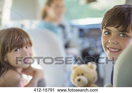 Portrait of happy brother and sister in back seat of car View Large Photo Image Stock Image - Portrait of happy brother and sister in back seat of car. Fotosearch