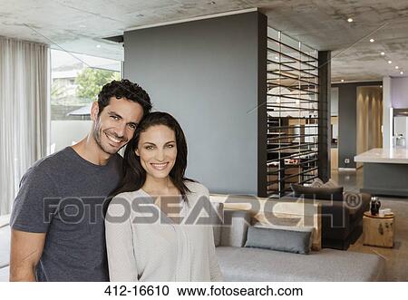 Portrait of happy couple in living room View Large Photo Image Stock Image - Portrait of happy couple in living room. Fotosearch