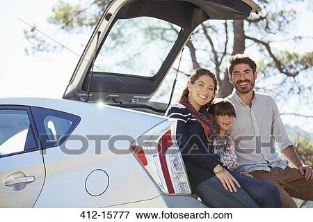 Portrait of happy family at back of car View Large Photo Image Stock Photo - Portrait of happy family at back of car. Fotosearch