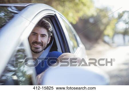 Portrait of happy man driving car View Large Photo Image Stock Photography - Portrait of happy man driving car. Fotosearch