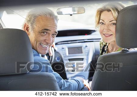 Portrait of happy senior couple inside car View Large Photo Image Stock Image - Portrait of happy senior couple inside car. Fotosearch