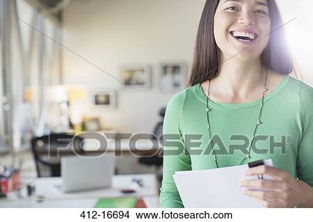 Portrait of laughing businesswoman in office View Large Photo Image Picture - Portrait of laughing businesswoman in office. Fotosearch