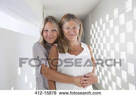 Portrait of mother and daughter hugging View Large Photo Image Stock Photo - Portrait of mother and daughter hugging. Fotosearch