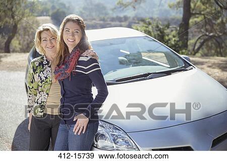 Portrait of mother and daughter outside car View Large Photo Image Stock Photo - Portrait of mother and daughter outside car. Fotosearch