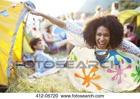 Portrait of playful woman laying on inflatable chair outside tents at music festival View Large Photo Image Stock Image - Portrait of playful woman laying on inflatable chair outside tents at music festival. Fotosearch