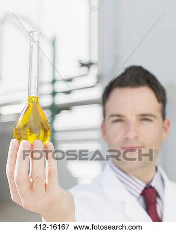 Portrait of scientist holding beaker with liquid View Large Photo Image Stock Photo - Portrait of scientist holding beaker with liquid. Fotosearch