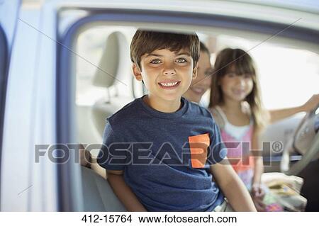 Picture - Portrait of smiling boy inside car. Fotosearch