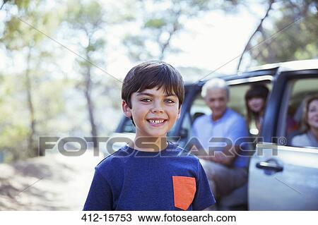 Portrait of smiling boy outside car View Large Photo Image Stock Image - Portrait of smiling boy outside car. Fotosearch