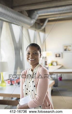 Portrait of smiling businesswoman in office View Large Photo Image Stock Photograph - Portrait of smiling businesswoman in office. Fotosearch
