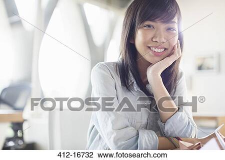 Portrait of smiling businesswoman with head in hands View Large Photo Image Stock Image - Portrait of smiling businesswoman with head in hands. Fotosearch