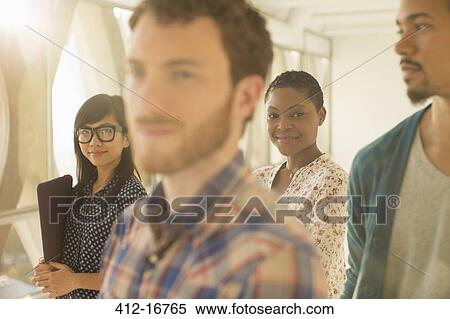 Portrait of smiling casual businesswoman with co-workers View Large Photo Image Stock Photography - Portrait of smiling casual businesswoman with co-workers. Fotosearch