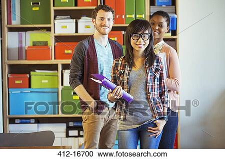 Stock Image - Portrait of smiling creative business people in office. Fotosearch