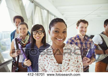 Stock Image - Portrait of smiling creative business people in office corridor. Fotosearch
