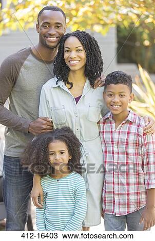 Portrait of smiling family outdoors View Large Photo Image Stock Image - Portrait of smiling family outdoors. Fotosearch