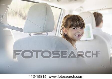 Portrait of smiling girl in back seat of car View Large Photo Image Stock Photography - Portrait of smiling girl in back seat of car. Fotosearch