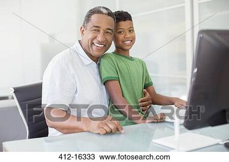 Portrait of smiling grandfather and grandson at computer View Large Photo Image Stock Image - Portrait of smiling grandfather and grandson at computer. Fotosearch
