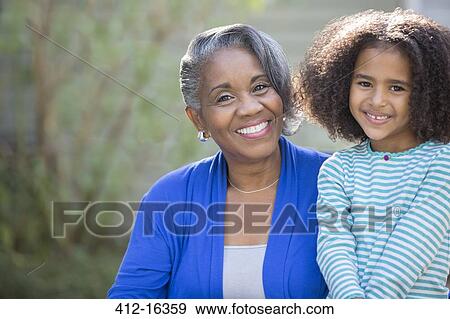 Stock Photo - Portrait of smiling grandmother and granddaughter. Fotosearch
