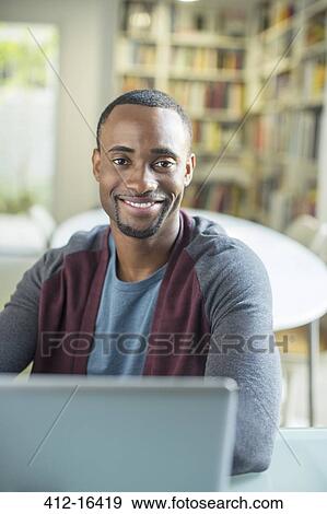 Portrait of smiling man at laptop View Large Photo Image Stock Photo - Portrait of smiling man at laptop. Fotosearch