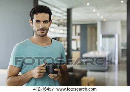Portrait of smiling man drinking coffee at home View Large Photo Image Stock Photo - Portrait of smiling man drinking coffee at home. Fotosearch