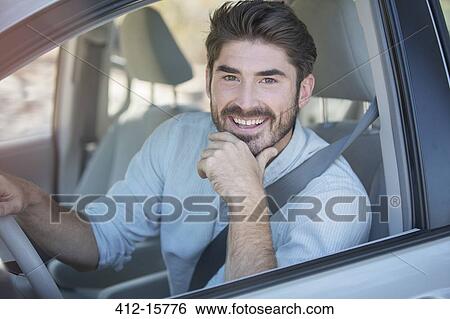 Portrait of smiling man driving car View Large Photo Image Stock Photograph - Portrait of smiling man driving car. Fotosearch